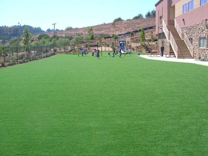 Open space in a school and children playing soccer.